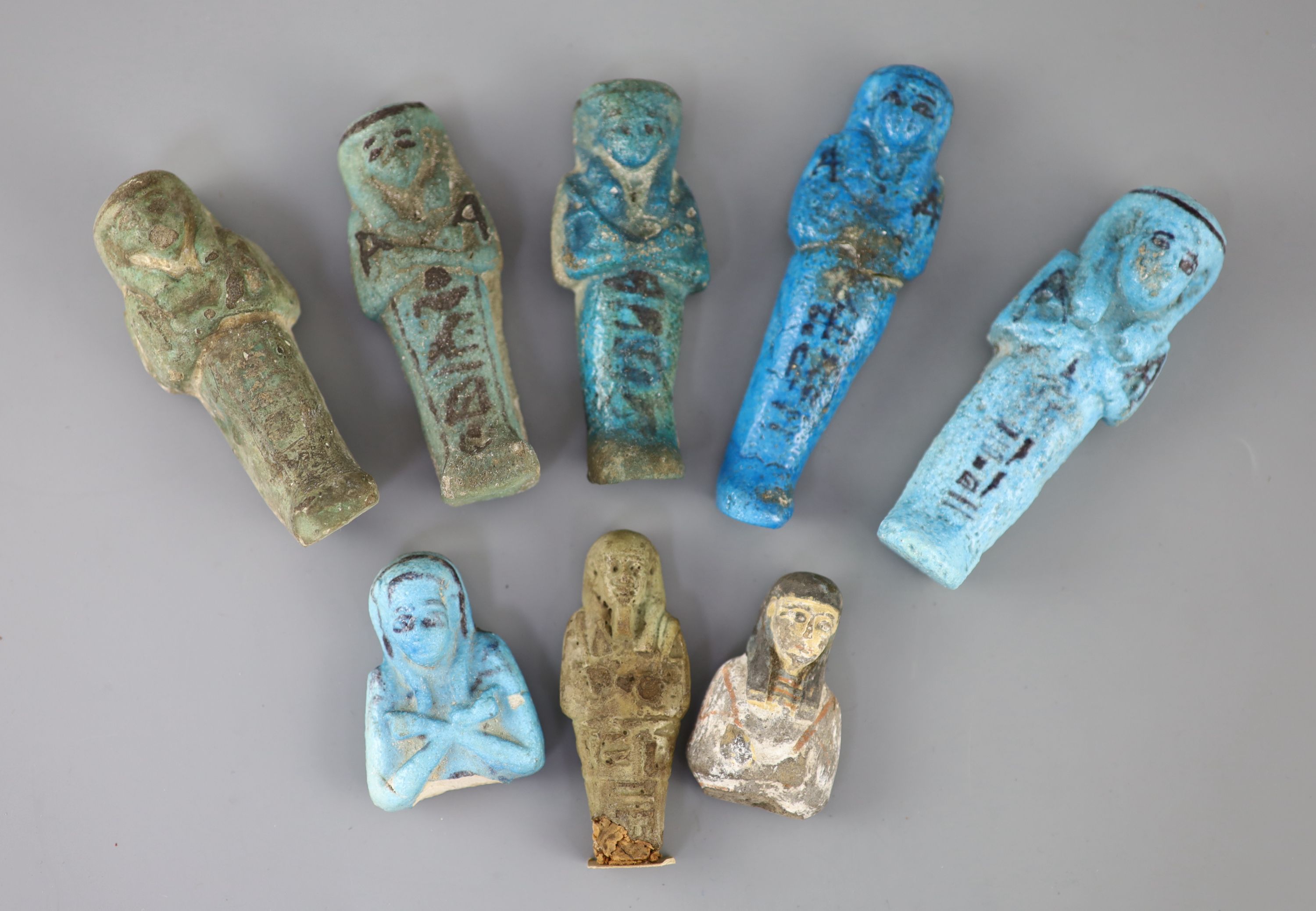 Five Egyptian turquoise glazed faience shabti and three fragments, New Kingdom to late period, Provenance - A. T. Arber-Cooke